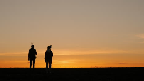 silhouette of farmers at sunset