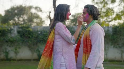 Indian-man-brings-his-wife-close-to-him-at-a-Holi-party