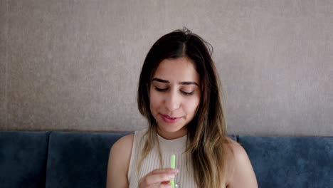 Beautiful-young-girl-drinks-coke-or-soda-with-a-big-enjoy-in-a-restaurant-or-cafe-while