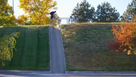 man jumps into a hill on their skateboard