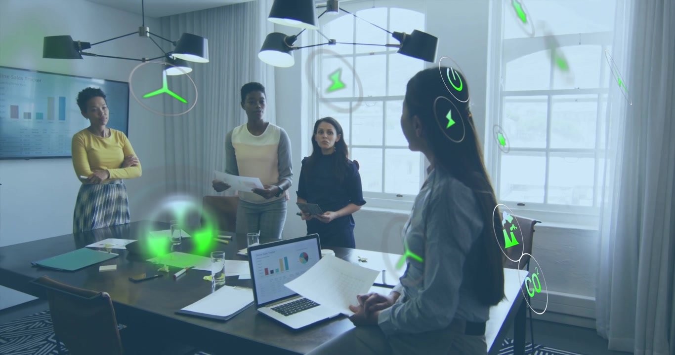 Animation of multiple icons over diverse female coworkers discussing reports in office