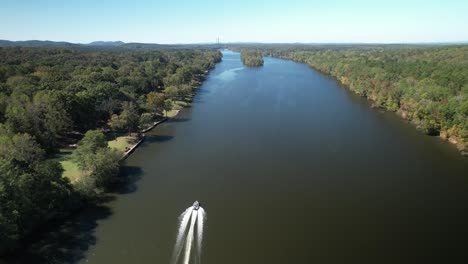 aerial of a boat travelling down the coosa river in childersburg, al