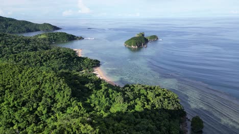 aerial flyover rainforest toward beach and islands, catanduanes, philippines