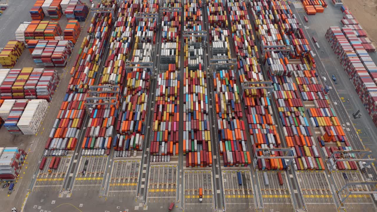 Top Down Aerial View of Cargo Ship and Port Infrastructure on River Thames London Showing International Trade and Logistics Operations