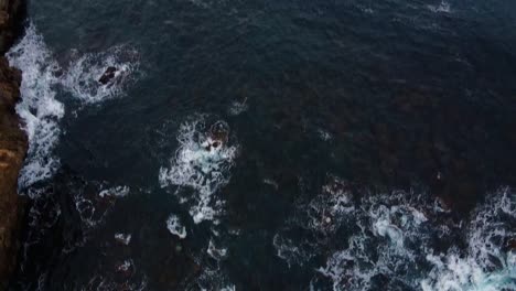 timelapse. aerial top view waves break on rocks in a blue ocean. sea waves on beautiful beach aerial view drone shot. ocean