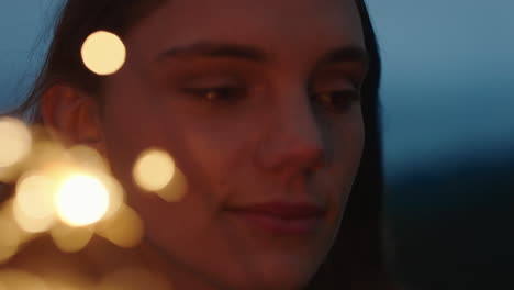 close-up-sparklers-happy-woman-celebrating-independence-day-enjoying-new-years-eve-celebration-having-fun-with-festive-fireworks-on-beach-at-sunset