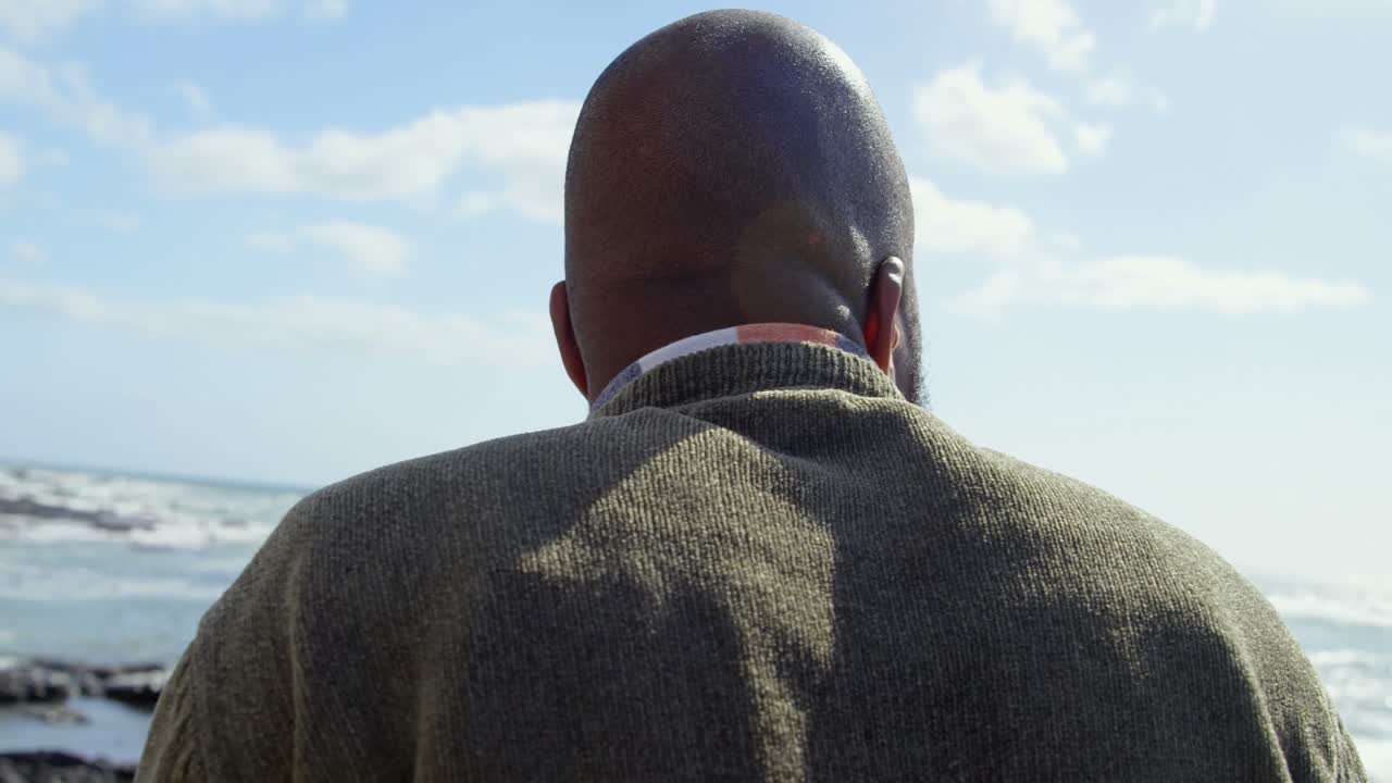 Man standing near sea side on a sunny day 4k