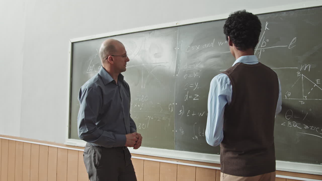 Student and Professor Solving Geometry Problem at Blackboard