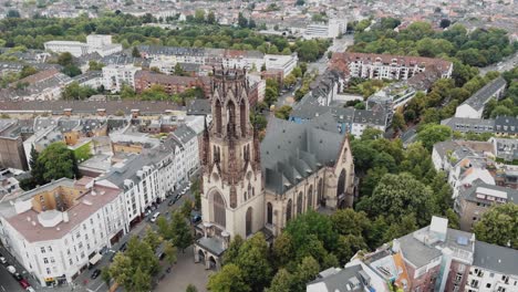 4k aerial footage circling the historic saint martin church building in cologne, germany