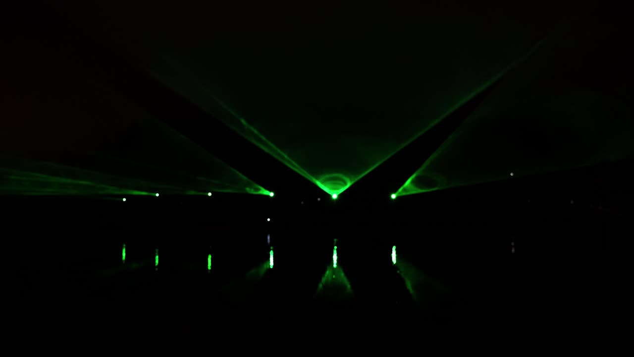 Static shot of light laser show performed at night