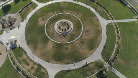 aerial - drone flyover of circular suburban park