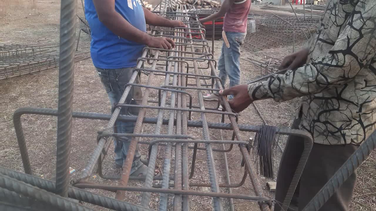 Making RCC Column after Design on Site. Construction workers attach steel rings to columns and beams. - Reinforcement concrete column as part of building structure at the construction site