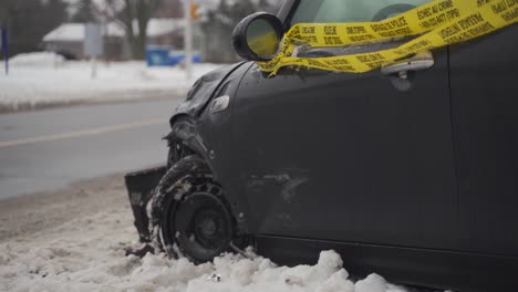 crashed car side view mini cooper on road in the snow