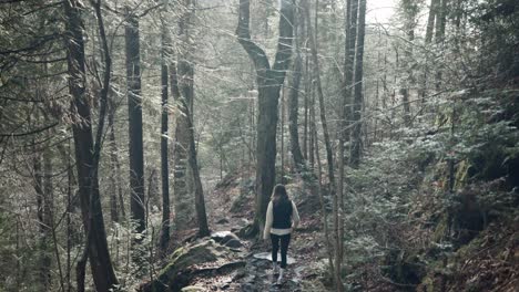 Grayscale-Portrait-Of-A-Woman-Walking-Through-Forest-Trail-At-Saint-Come,-Quebec,-Canada