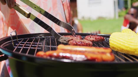 Close-up-of-diverse-group-of-friends-having-barbecue-at-a-pool-party