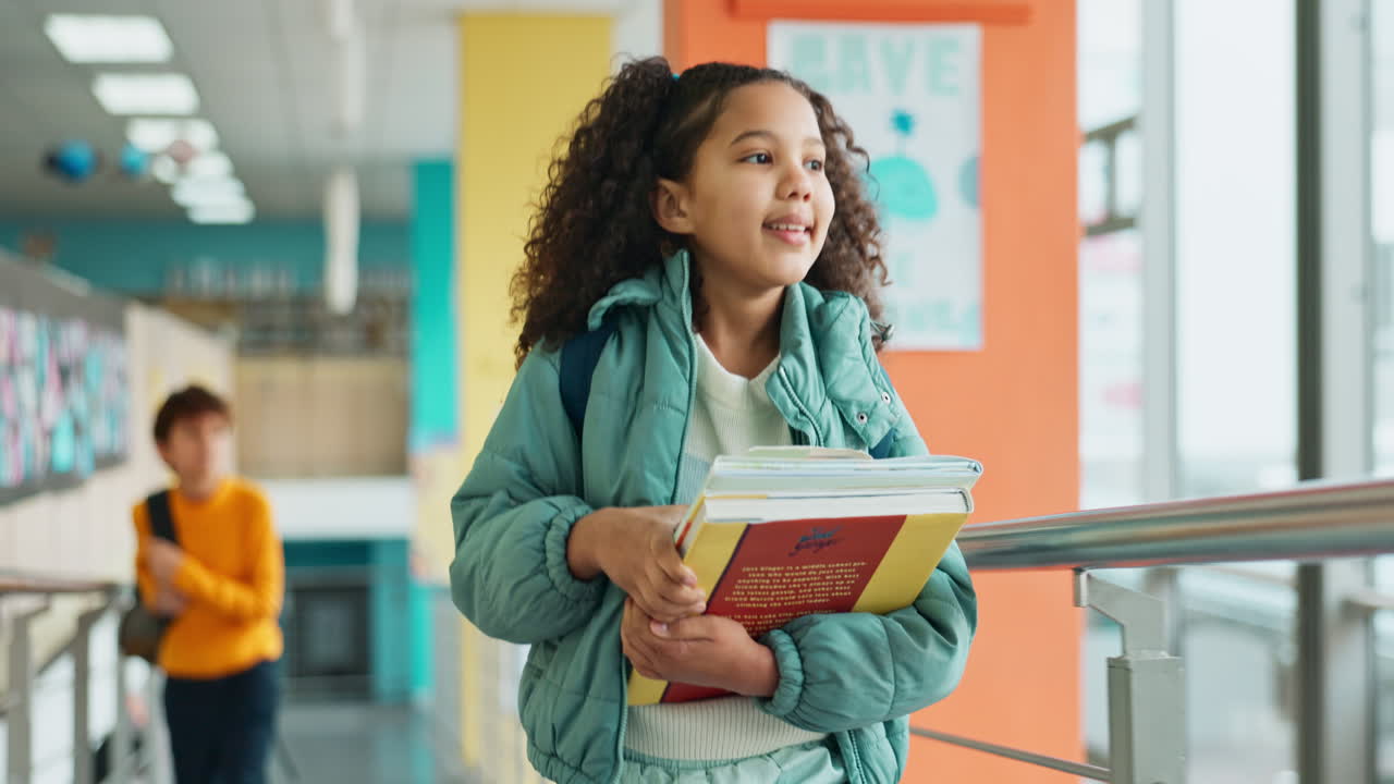 A young student walking down a school hallway