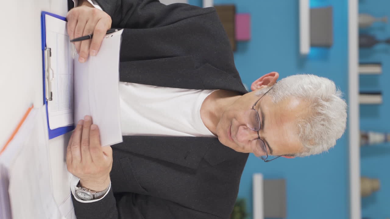 Vertical video of Home office worker man works confused.