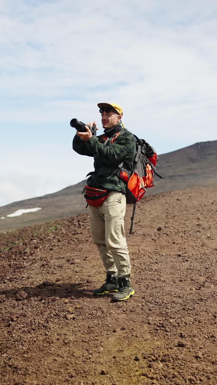 Adventurous Photographer Capturing Images in Barren Mountain Terrain