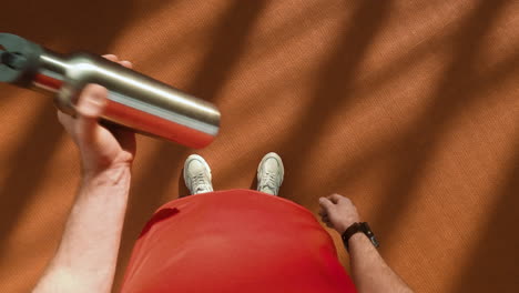 overhead view of a person with a hydration bottle
