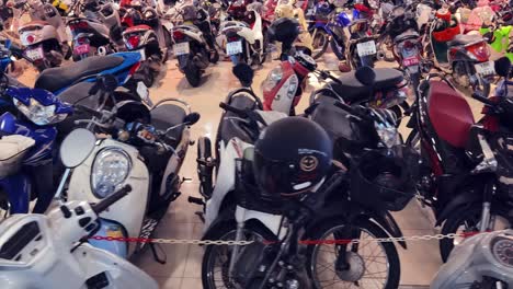 many motorbikes and scooters in a store