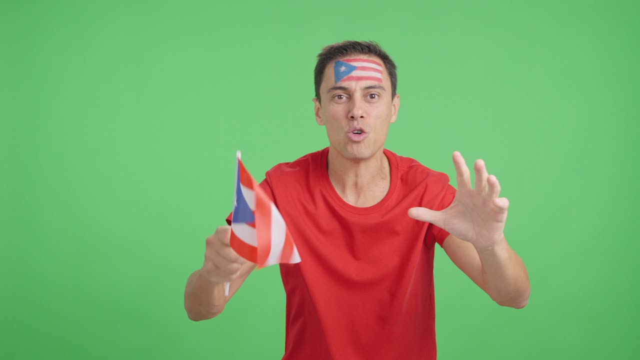 Man cheering for Puerto Rico screaming and waving a national flag