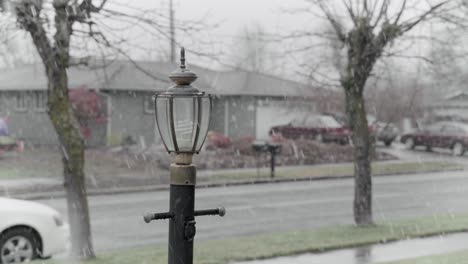 light post in the middle of light snowfall of a suburban neighborhood | 4k