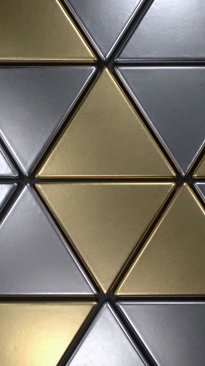 Vertical video: Panning camera showing metal triangle tiles in cab to show lower row, showing seams
