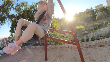 Child-having-exciting-experience-on-a-rope-swing-on-the-playground