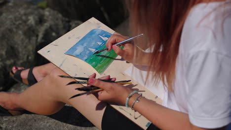 woman painting a seascape watercolor