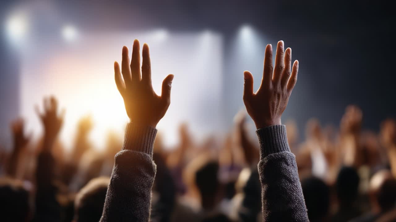 A Crowd's Enthusiastic Participation with Outstretched Hands Under Dramatic Lighting, Capturing the Spirit of Engagement and Unity in a Live Event Atmosphere