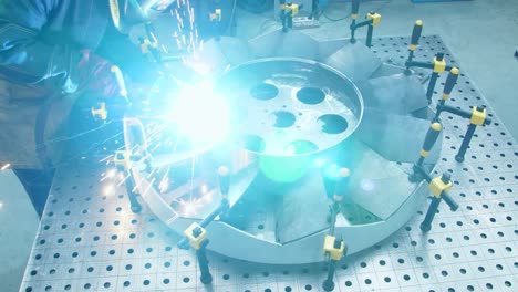 Workman-making-welding-of-channel-blades-of-huge-fan.-Production-of-motor