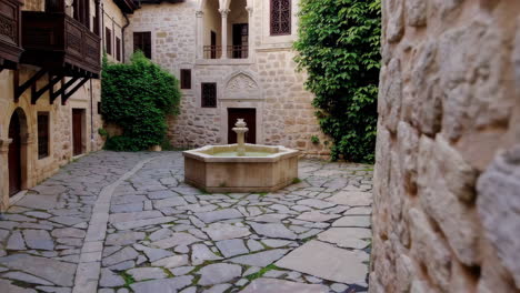 ancient courtyard with fountain and balconies