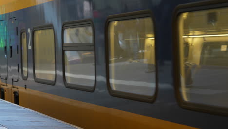 Passenger-Train-Passing-By-The-NS-Station-In-Rotterdam-Blaak,-Netherlands