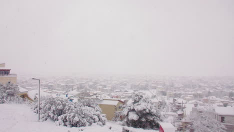 Rare-Medea-blanket-snow-cover-across-Athens-Greece-neighbourhood-city-landscape-slow-pan-right