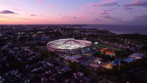 Aerial-Above-Monumental-Stadium,-Home-of-Argentine-Soccer-Team-and-River-Plate-Club,-Night-in-the-Belgrano-Neighborhood,-Buenos-Aires-City,-Argentina