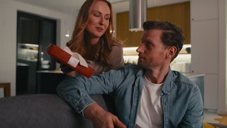 woman giving a present for his husband for valentines's day