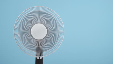 electric fan against blue background