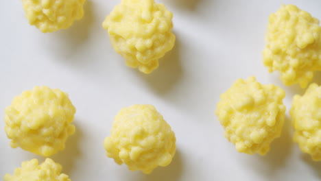 Macro-shot-of-yellow-virus-cells-on-a-white-surface-with-light-form-the-left