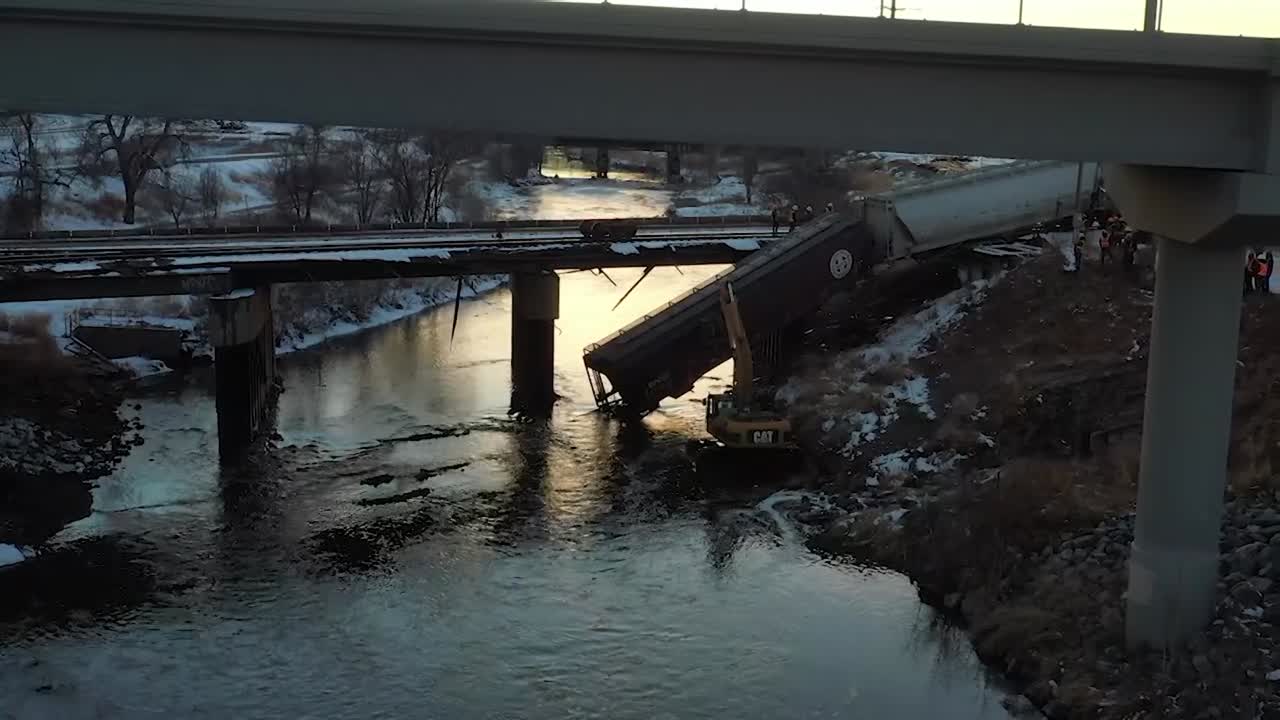 TRAIN HANGING OFF A BRIDGE FROM DERAIL