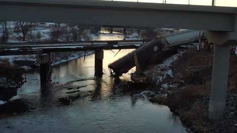 train hanging off a bridge from derail