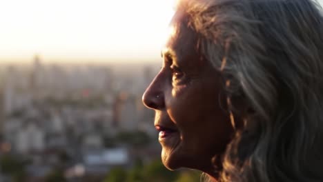 a moment of reflection: an elderly woman gazes thoughtfully at the cityscape during a golden sunset, capturing a sense of wisdom and tranquility in an urban setting