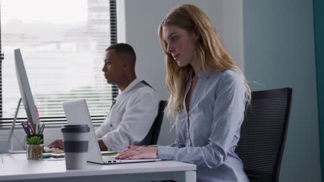 man and woman working on computers