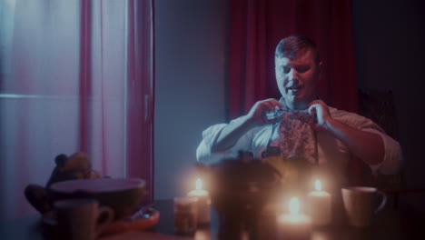 gentleman adjusting tie by the window