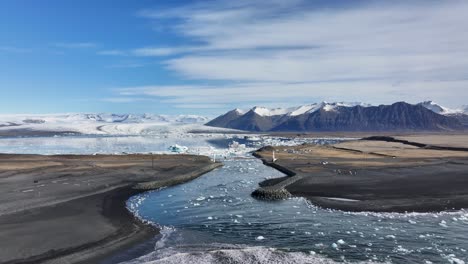 iceland's majestic landscape unfolds in this stunning aerial image, where glacier water flows effortlessly