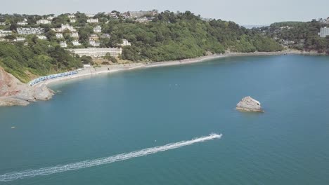 a boat cruising on the water in a beautiful bay