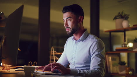 businessman typing on computer while working late