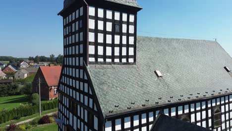 old-half-timbered-catholic-church-bottom-cross-to-church-tower-aerial