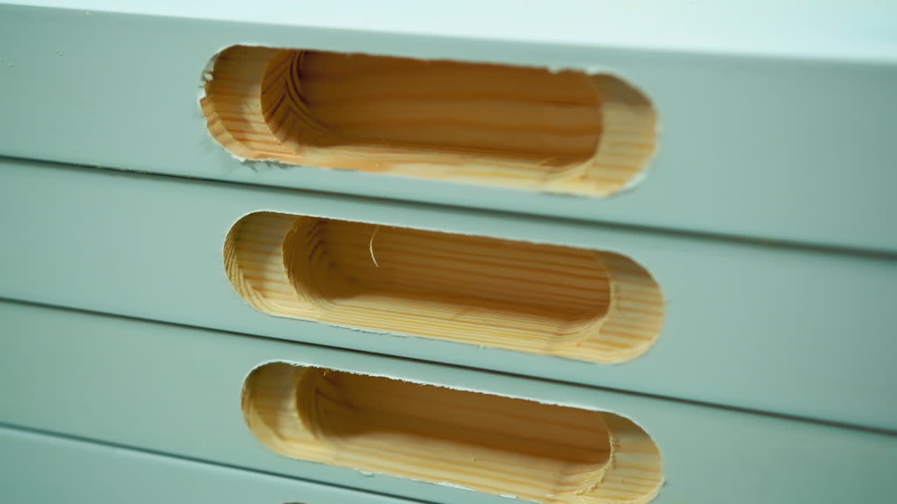Doors production. Stack of wooden boards with holes inside. Making furniture in the workshop. Close-up.