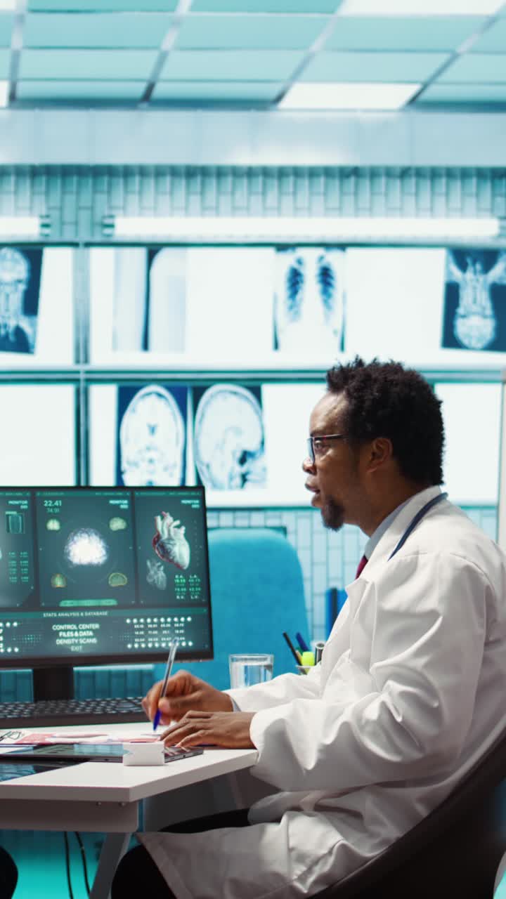 African American Doctor Analyzing Medical Scans on Computer in Lab