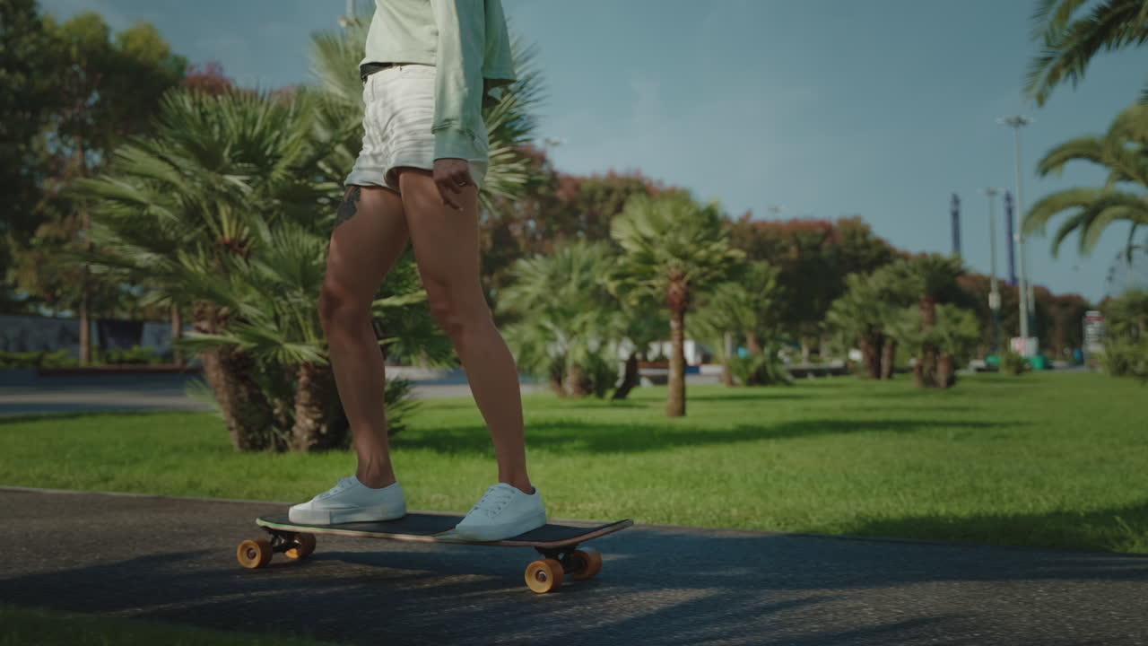 Woman Skateboarding in a City Park